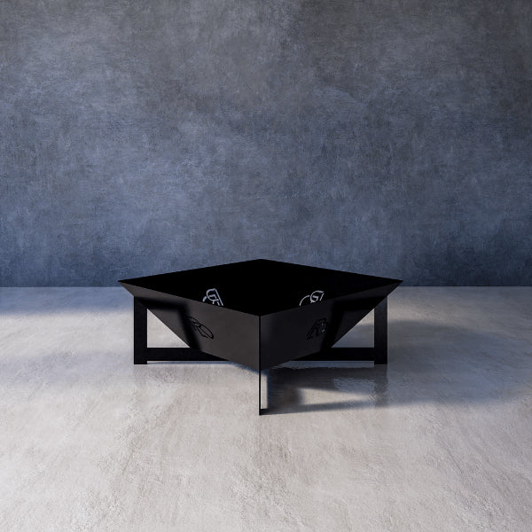 Basin black firepit against a textured gray wall