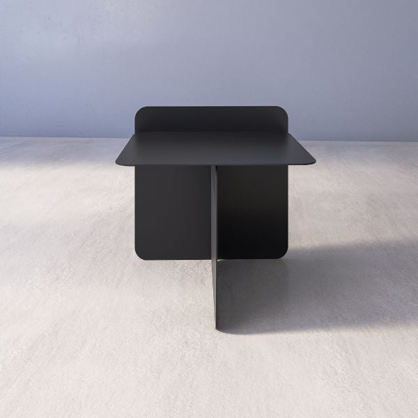 Cairo Side Table — Black modern side table on a light gray floor with a neutral background