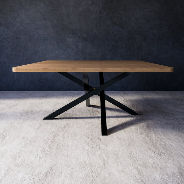 Cassie dining table with wooden top and black metal legs against a grey wall