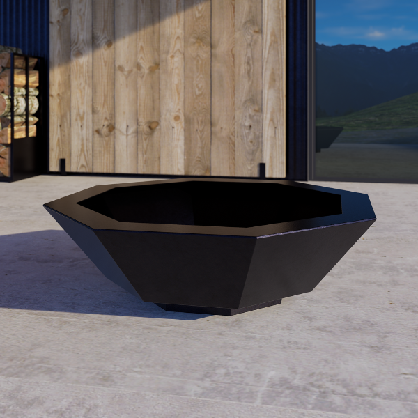 Hex firepit – black geometric outdoor fire pit on a concrete surface with wooden wall and mountain view in the background