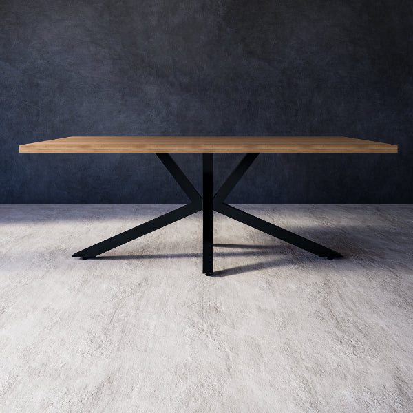 Nessa dining table with wooden top and black metal legs against a grey wall