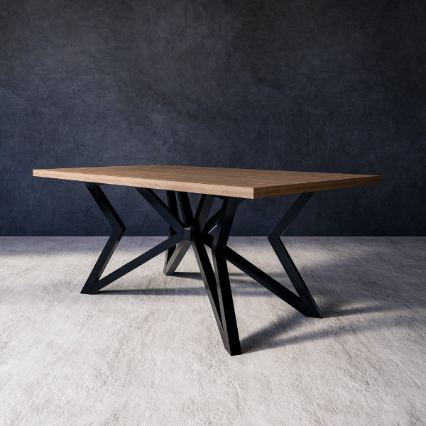 Phoenix dining table with wooden top and black metal legs against a dark wall