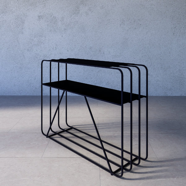 Sierra console table – black metal console table against a gray concrete wall