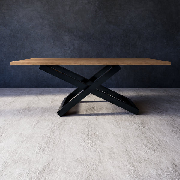 Sylvana dining table with wooden top and black metal base set against a dark wall